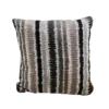 Striped pillow in beige with black, brown, tan, and light blue stripes