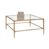 Large square coffee table with muted gold edges, legs and a glass top.