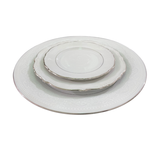 Mismatched fine china plates with silver edging stacked - dinner plate, salad plate, bread plate.