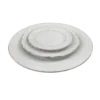 Mismatched fine china plates with silver edging stacked - dinner plate, salad plate, bread plate.