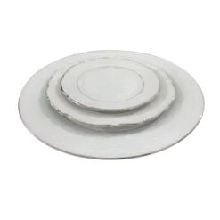 Mismatched fine china plates with silver edging stacked - dinner plate, salad plate, bread plate.