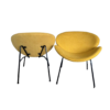 Two mustard MCM chairs - one facing forward and one facing backwards