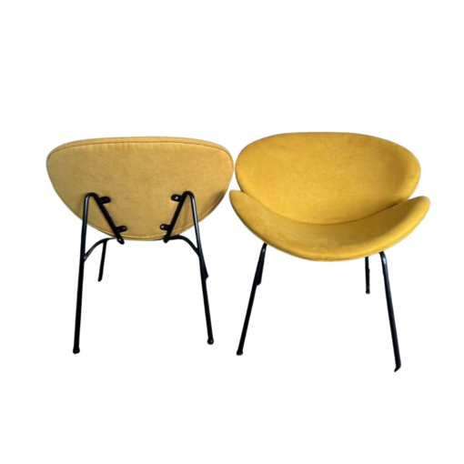 Two mustard MCM chairs - one facing forward and one facing backwards