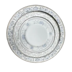 Three vintage plates of different sizes stacked on top of each other. Mismatched patters all in hues of blue.