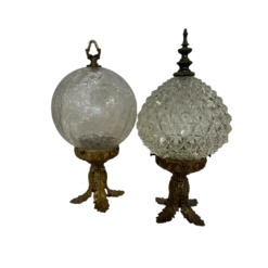 Pair of vintage decorative table top globes. Brass base with cut glass top and brass decorative top.