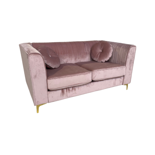 Soft pink velvet sofa with tufted back, two large cushions, square arms and gold legs. Includes two round matching pillows. Side view