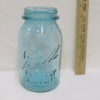 Light blue jar with ruler next to it showing 7 inches tall