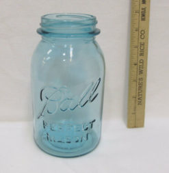 Light blue jar with ruler next to it showing 7 inches tall
