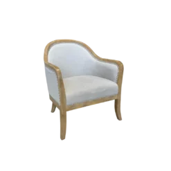 Armchair with light wood frame around the top, down the arms, and into the legs. Soft beige fabric on seat, back, and around the back of the chair. Silver nailhead trim.