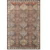 Boho rust colored area rug with geometric design.