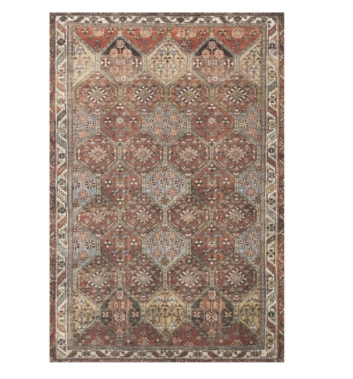 Boho rust colored area rug with geometric design.