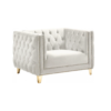 Side view of cream / white velvet square oversized chair with button tufted sides and back, gold nailhead trim and gold legs.