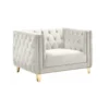Side view of cream / white velvet square oversized chair with button tufted sides and back, gold nailhead trim and gold legs.