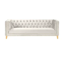 White velvet square sofa with button tufting and gold nailhead trim and legs
