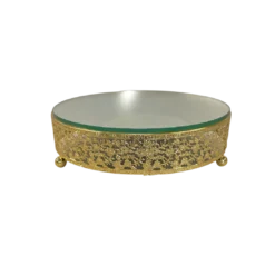 Ornate round cake stand with intricate gold design on the 2.5 inch edge. Small ball feet. Mirror top.