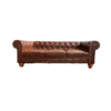 Brown faux leather sofa with 3 cushions, tufted back, round arms and brown wooden legs against a white backdrop.