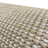 Close up on texture of Edwin Rug. White woven lines in a repeating pattern on tan backing.