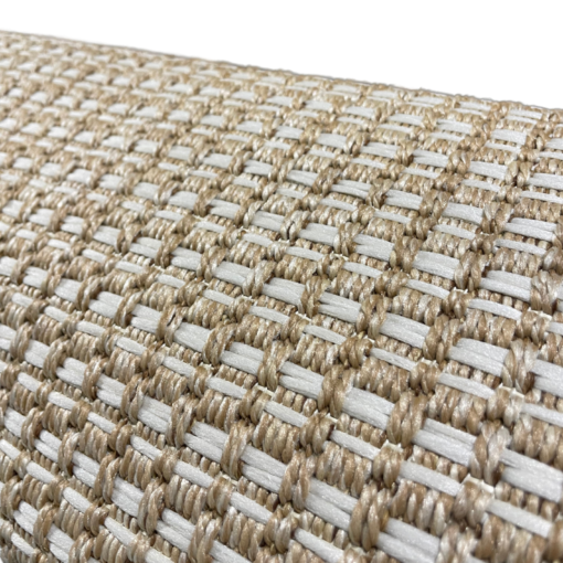 Close up on texture of Edwin Rug. White woven lines in a repeating pattern on tan backing.