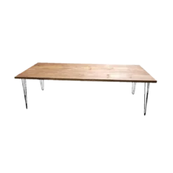 Wooden farm table with medium stain. Black metal hairpin legs on each corner.