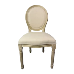 A french style chair with light wood framing and cream upholstered back and seat.