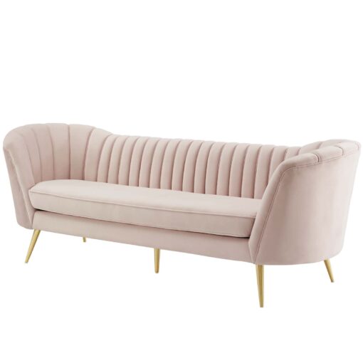 Soft pink velvet sofa with vertical tufting and gold legs