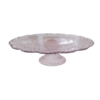 Light pink glass pedestal cake stand with scalloped edges.