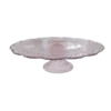 Light pink glass pedestal cake stand with scalloped edges.