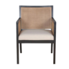 Dark wooden chair with strong angles. Cane on back and arms. Cream upholstered seat.