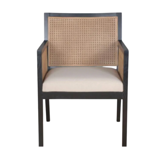 Dark wooden chair with strong angles. Cane on back and arms. Cream upholstered seat.