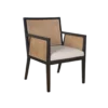 Dark wooden chair with strong angles. Cane on back and arms. Cream upholstered seat.