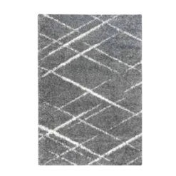 Plush gray shag rug with white lines at angles making messy diamond designs.