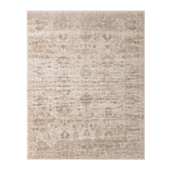 Tan, beige, ivory and gray hues make up subtle geometric patterns in this low pile rectangular rug.