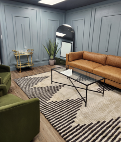 Leather sofa against blue gray walls with a geometric black and white rug.