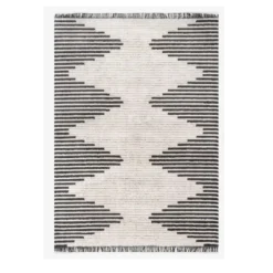 Large gray and beige rug with alternating stripes that create beige diamonds down the middle with gray triangles on the sides.