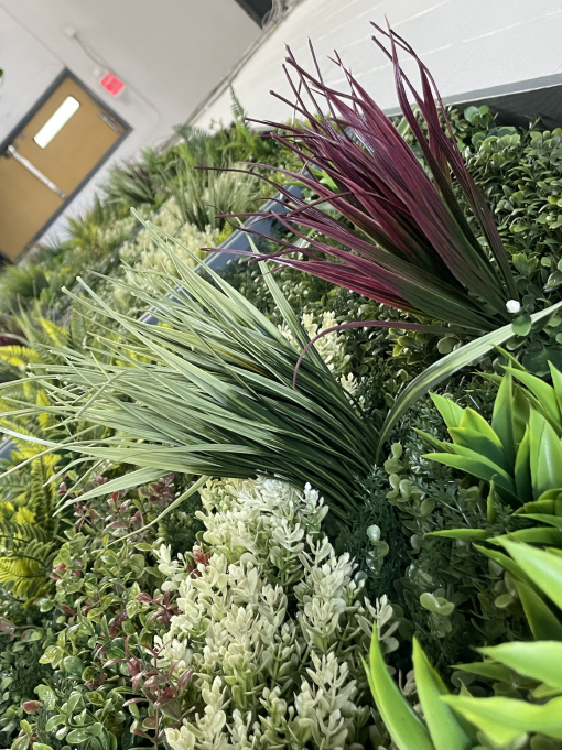 Detail on the greenery wall with texture, colors, and depth