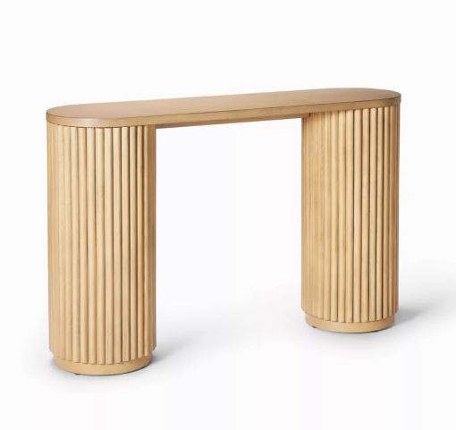 Side angle of a wooden console table with thick round legs and an oval flat top.