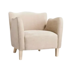 Velvet wing arm chair in beige. Scallop top, high arms, light wooden legs.