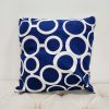 Royal blue square pillow with white geometric repeating design with irregular circles