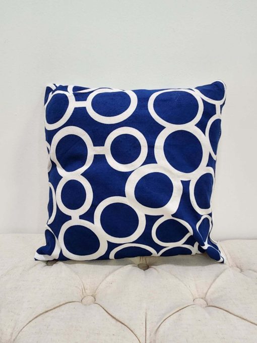 Royal blue square pillow with white geometric repeating design with irregular circles