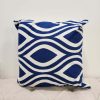 Royal blue square pillow with white geometric repeating peacock design