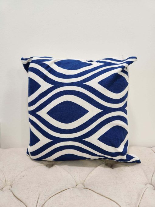 Royal blue square pillow with white geometric repeating peacock design