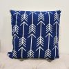 Royal blue square pillow with white geometric repeating design with arrows