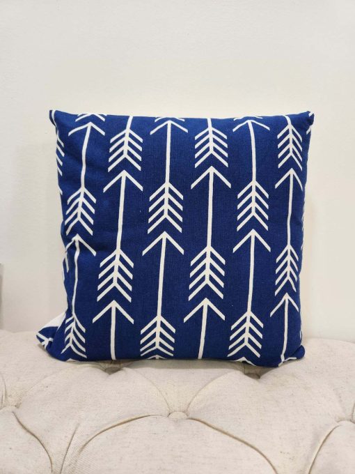 Royal blue square pillow with white geometric repeating design with arrows