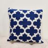 Royal blue square pillow with white geometric repeating design - quatrefoil