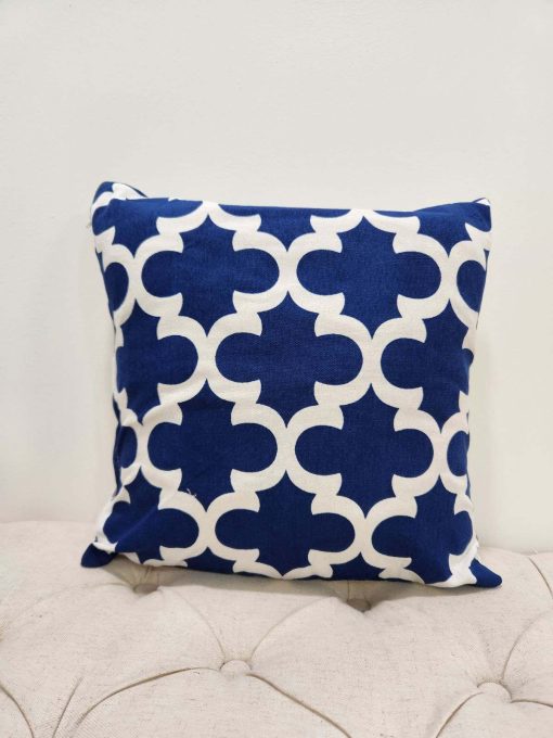 Royal blue square pillow with white geometric repeating design - quatrefoil