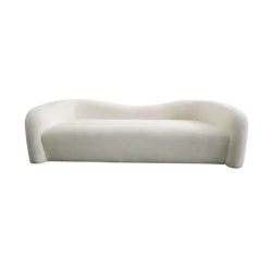 Modern beige shearling sofa with wave back. One piece cushion / seat. No visible legs.