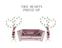 One dusty pink settee with two gold heart shaped candelabras on either side.