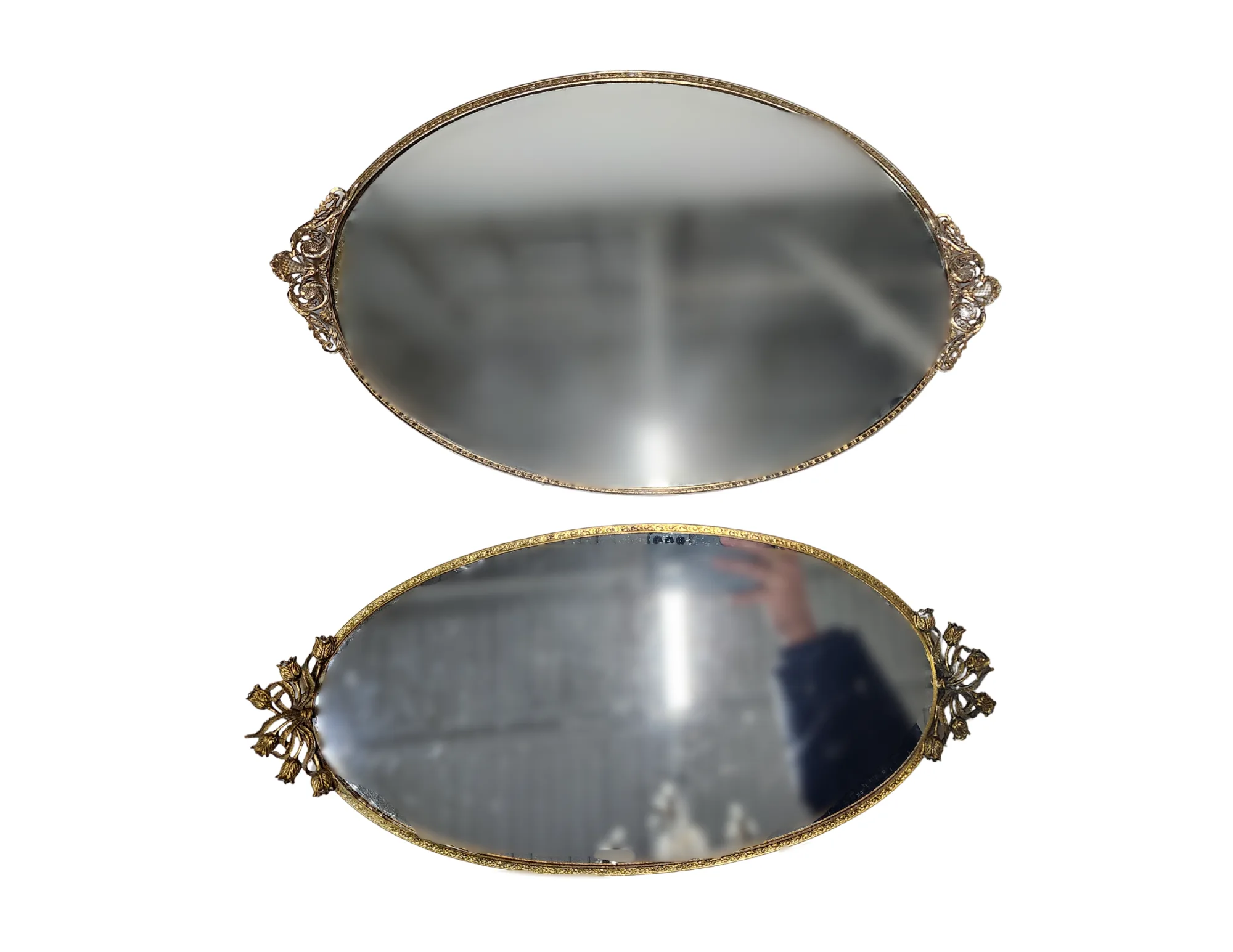 Misty Mirrored Tray Set (2) WEBP Two oval mirrored serving trays with ornate gold trim.
