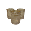 A trio of 3-inch light amber mercury glass votive candle holders with a primrose embossed design