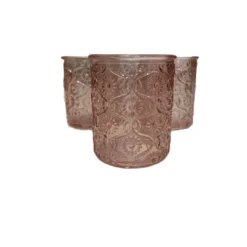 Three blush pink embossed glass votive candle holders.
